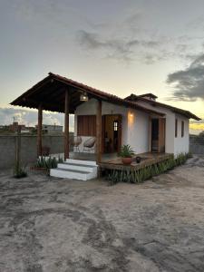 a small house with a porch and stairs to it at Casa.mar Casa Hotel in Barra Grande