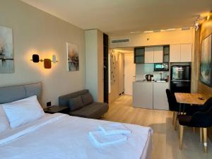 a hotel room with a bed and a kitchen at Sea Breeze Studios in Netanya