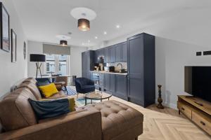 イーストボーンにあるGrande View 7のソファとキッチンのあるリビングルーム