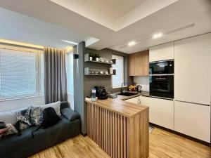 a living room with a couch and a kitchen at Апартамент Мегилукс 2 in Blagoevgrad