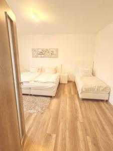Posteľ alebo postele v izbe v ubytovaní Trio Apartments