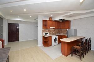 a kitchen with a table and a stove top oven at Apartment in Abovyan Street, Yerevan in Yerevan