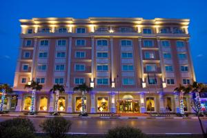 a building lit up at night with christmas lights at Latanya Palm & SPA Hotel Antalya in Antalya