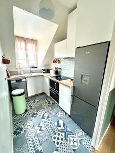 a kitchen with a black and white tile floor at Perle Marine Haussmannienne - Lumineux & Calme - Proche Gare & Plage in Dieppe