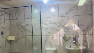 a bathroom with a toilet and a shower at ekhaya guesthouse in Secunda