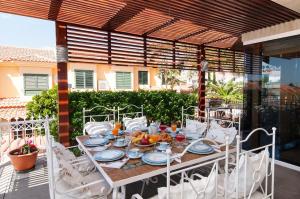 a table with plates of food on a patio at Sonnenland House for 12 by VillaGranCanaria in Maspalomas