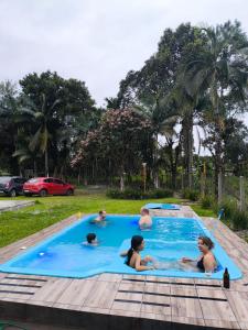 a group of children playing in a swimming pool at Rancho Bertotti in Guaratuba