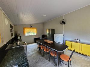 a kitchen with a table and chairs in a room at Rancho Bertotti in Guaratuba