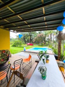 a patio with a table and chairs and a pool at Rancho Bertotti in Guaratuba +14 photos