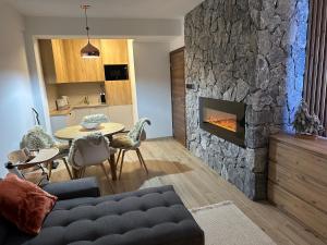 a living room with a couch and a fireplace at Kamzík 51 Donovaly in Donovaly +25 photos