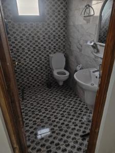 a bathroom with a toilet and a sink at Villa Banati in Djerba