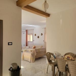 a bedroom with a bed and a table and chairs at Villa Banati in Djerba