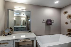 a bathroom with a sink and a large mirror at Ocean View Splendor in Corpus Christi +49 photos