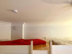 a bedroom with two beds with red sheets at Pink Gem, Kamppi in Helsinki