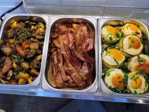 three plastic containers of food with eggs and meat at Greg&Tom Beer House Hostel in Krakow