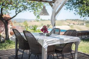 a white table and chairs on a patio at Apartment Casa Norina in Notaresco
