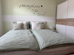 a bedroom with a large bed with white sheets and pillows at Apartment Bad Breisig in Bad Breisig