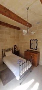 a bedroom with a bed and a dresser in a room at 71 San Antonio in Victoria +30 photos