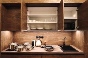 a kitchen counter with pots and pans and a sink at Vila Notre-Dame - Boutique design apartments in Mariánské Lázně