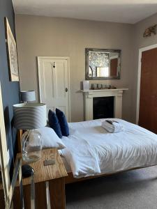 a bedroom with a large bed with blue pillows at Kelston Guest House in Weymouth