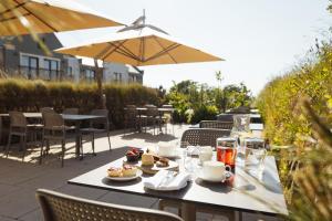 a table with food and drinks on a patio at Twr y Felin Hotel in St. Davids