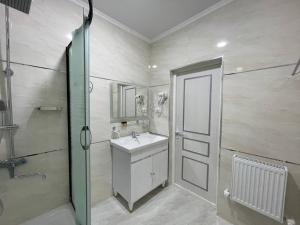 a bathroom with a sink and a shower at Anor Qal'a in Khiva +24 photos