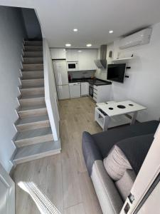 a living room with a staircase and a couch at Casita Playa Yolanda in Santa Pola +13 photos