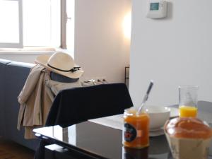 a person wearing a hat sitting at a table at Le coeur d'Angoulême, calme et spacieux in Angoulême +44 photos