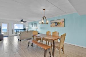 a dining room and living room with a table and chairs at Saida Towers IV #602 in South Padre Island