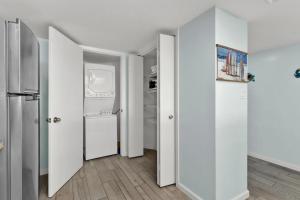 a hallway with white walls and a refrigerator at Saida Towers IV #602 in South Padre Island