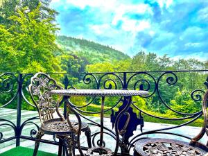 a wrought iron table and chairs on a balcony at VILLA FIRST im Sophienhof in Königswinter