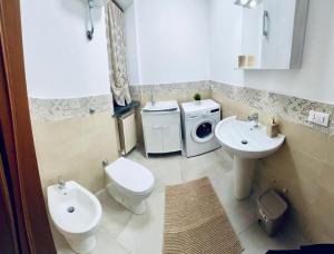 a bathroom with a toilet a sink and a washing machine at La casa dar braschi in Il Prato +34 photos