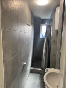 a bathroom with a shower and a toilet and a sink at Bijeljina Central in Bijeljina