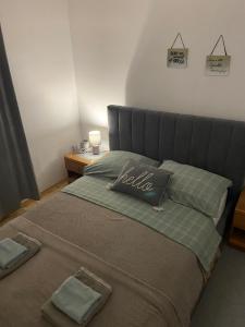 a bed with two pillows on it in a bedroom at Oguic apartman in Pag