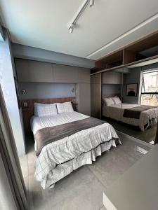 a bedroom with two beds and a window at Flat Beira mar em Tambaú in João Pessoa