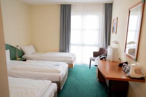 Postel nebo postele na pokoji v ubytování Trip Inn Hotel Dasing-Augsburg