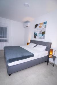 a bedroom with a large bed in a white room at Black Diamond in Novalja