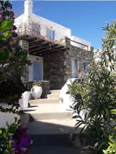 a stone house with a staircase leading up to it at Maridina House in Livadi