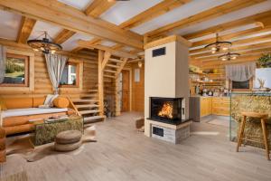a living room with a fireplace in a log cabin at Haus Dorine in Fužine - Haus für 6 Personen in Fužine