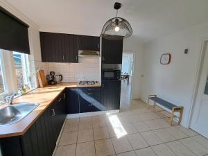 a kitchen with a sink and a counter top at Charmante vakantiewoning met Sauna, Zeeland, VP002 in Heinkensand