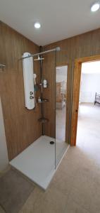 a shower with a glass door in a room at La Vista Secreta in Oria +23 photos