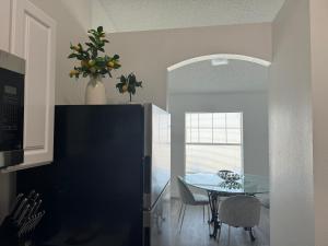 a kitchen with a table and a dining room at Cozy Costal Home in Vero Beach