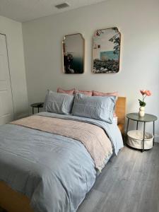 a bedroom with a bed and two mirrors on the wall at Cozy Costal Home in Vero Beach