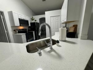 a kitchen with a sink and a counter top at Cozy Costal Home in Vero Beach