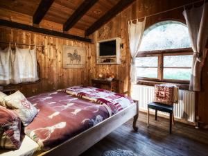 a bedroom with a bed in a room with a window at Agriturismo Randis in Piano dʼArta