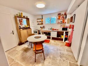 a kitchen with a table and a small table and chairs at Beau studio dans mas provençal in Avignon