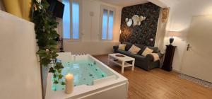 a living room with a tub in the middle of a room at Sérénité au Palais Suite romantique Jacuzzi in Avignon +18 photos