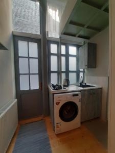 a kitchen with a washing machine and a washer at Sweet Home in Tbilisi City