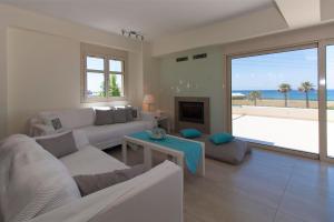 a living room with a couch and a fireplace at Villa Eco Blu in Marathopolis