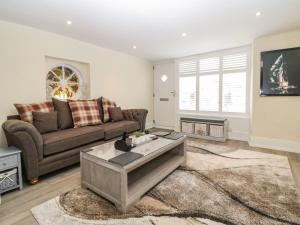 a living room with a couch and a coffee table at Harbour Cottage in Torquay